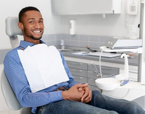 Dental patient smiling while relaxing in treatment chair