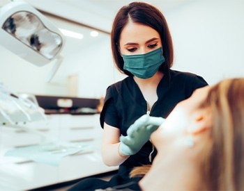 Dentist examining patient's teeth