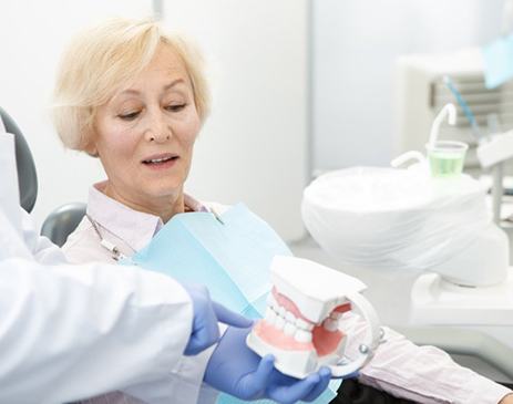 Patient and dentist discussing dentures during a consultation