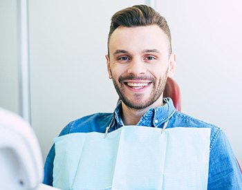 Man smiling while sitting in treatment chair