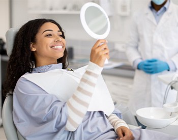 Woman smiling at reflection in mirror