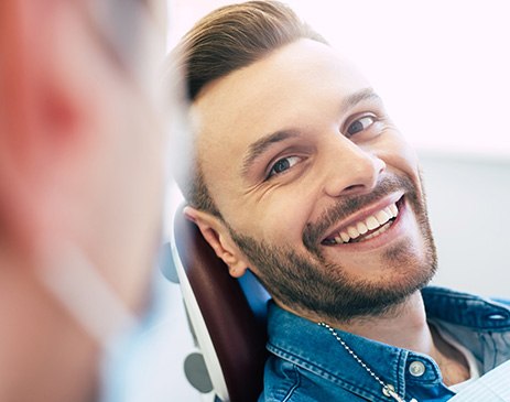 Man smiling at dentist in treatment chair