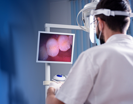 Dentist looking at picture of teeth taken with intraoral camera