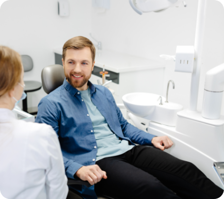 Male dental patient talking to dentist