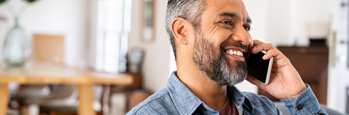 Close-up of bearded man talking on phone