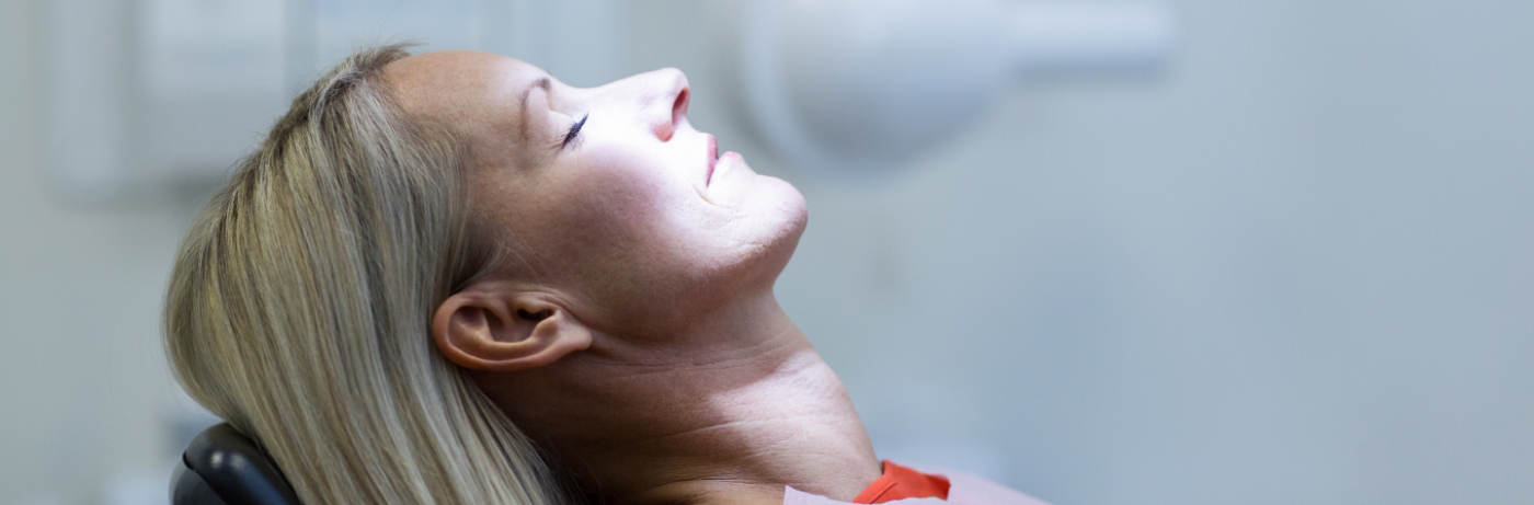 Woman in dental chair relaxing after sedation dentistry in Fort Smith