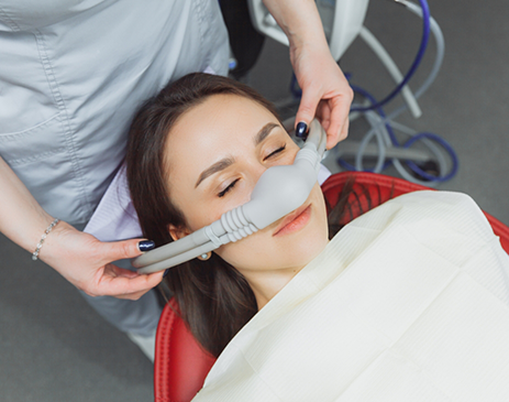 Woman having nasal mask placed for nitrous oxide sedation