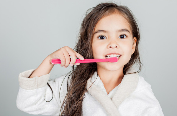 Young girl brushing her teeth.